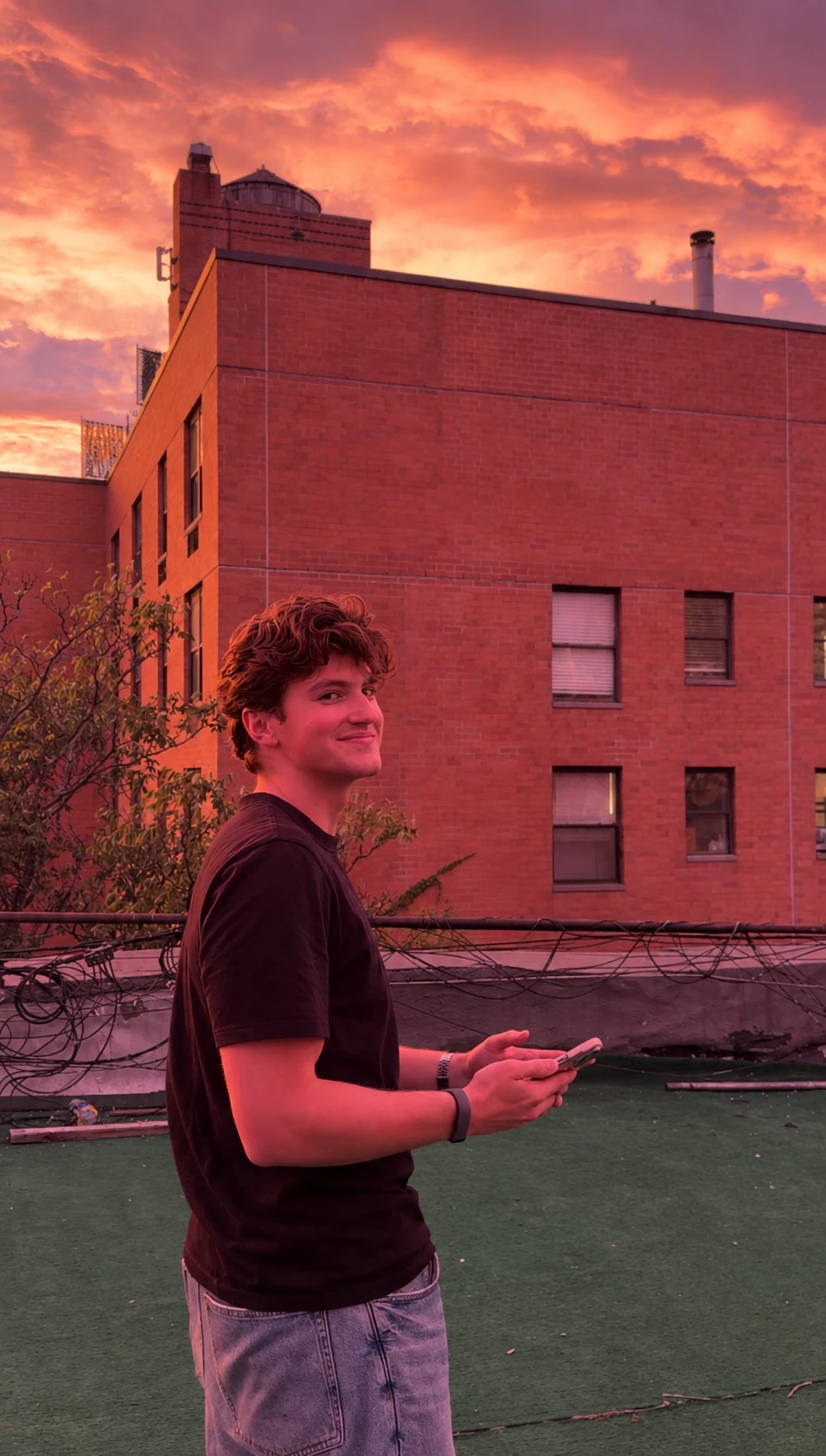 Smiling on a rooftop at sunset