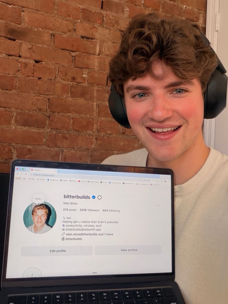 Holding up a laptop showing the bitterbuilds Instagram profile with 541K followers